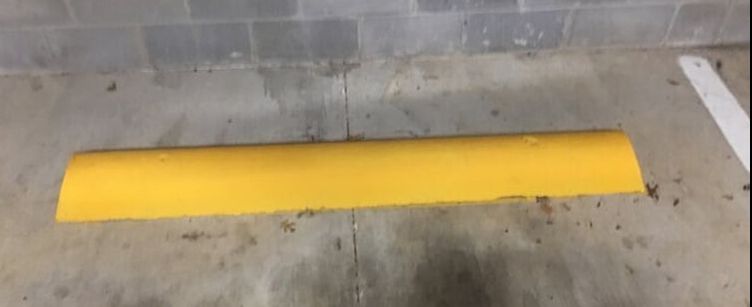 Yellow wheel stops in your parking lot in Azle, Texas