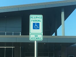 Handicap metal sign in parking lot in Flower Mound, TX